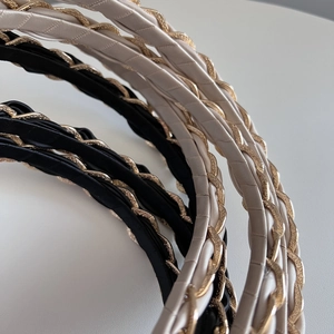 Elegant woven chain headband set in black and cream satin for chic hair styling