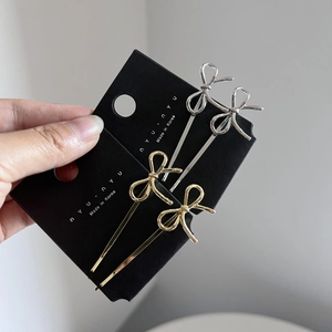 Handheld display of sweet Korean style gold and silver metal bow hair clips on cards