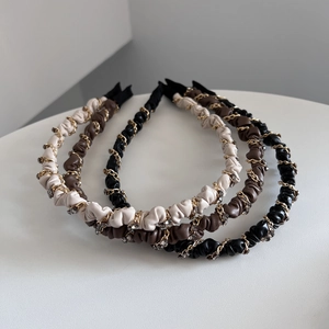 Detail of leather headbands with gold chains and sparkling crystals in three colors