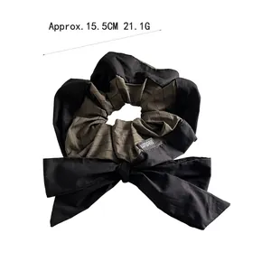 Striped bow scrunchie for women with vintage collegiate style and fabric texture