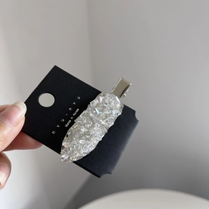 Detail of Korean crystal hair clip with silver duckbill base on branded paper card