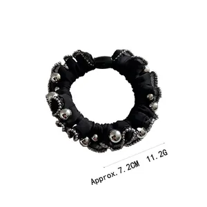 Elegant black scrunchie with lace edges and silver bead details, approx. 7.2cm diameter