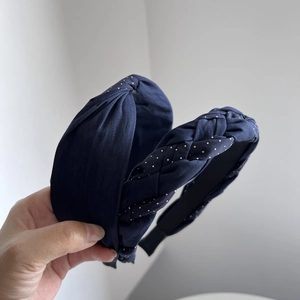 Navy blue braided and knotted fabric headbands with white polka dots for women
