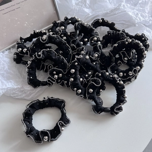 Elegant black scrunchie with beaded edges and faux pearls for a vintage ponytail look