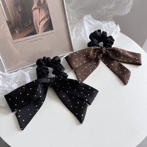 Elegant bow hair scrunchies with white heart patterns in black and dark brown fabric