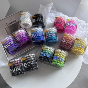 Set of 12 boxes showing various gradient TPU spiral hair ties in organized packaging