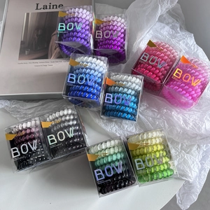 Gradient TPU telephone cord hair ties in a clear gift box with various vibrant colors