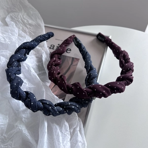 Polka dot twist headbands in navy blue and burgundy fabric on aesthetic background
