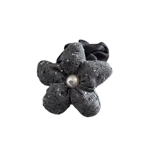 Elegant grey tweed flower hair tie with a central pearl accent on a plain white background
