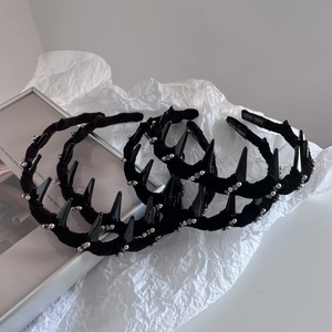 Three punk style black velvet headbands with silver beads and spikes on art paper
