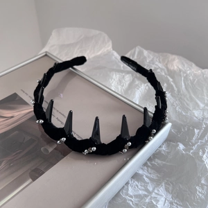 Macro shot of gothic black velvet headband with silver studs and rhinestones detail
