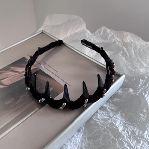 Detail of handmade purple velvet headband featuring black spikes and silver beads