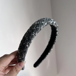 Gros plan du serre-tête en tweed gris rembourré avec texture tissée et doublure mate