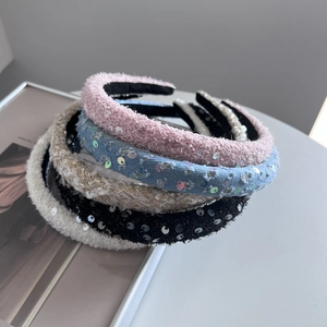 Macro shot of assorted sequined tweed headbands in pink, blue, gold, black, and ivory colors