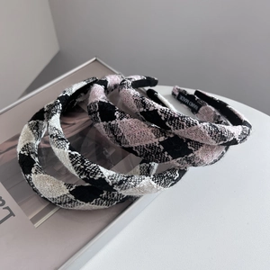 Three padded tweed headbands in black, white, and pink plaid patterns with handmade labels