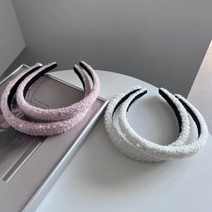 Elegant tweed headbands with sequins in pink and white set shown on a minimal white table