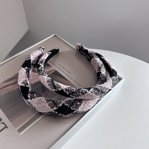 Detail of tweed headband set with hand made label showing woven texture and pattern