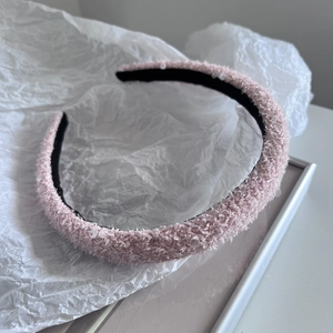 Detail showing pink fuzzy sponge headband with sparkling sequins and black inner lining