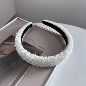 Detailed view of soft white fleece headband texture with anti-slip inner lining