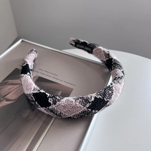 Detail of handmade plaid headband showing inner anti-slip strip and woven texture