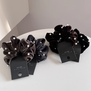 Elegant velvet hair scrunchies set with white pearls for a French vintage ponytail style