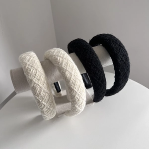 Elegant tweed and plush wide headbands in cream and black colors for high crown styling