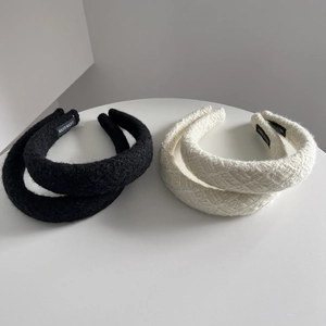 Detail of tweed and velvet headbands featuring the handmade label on the inner side
