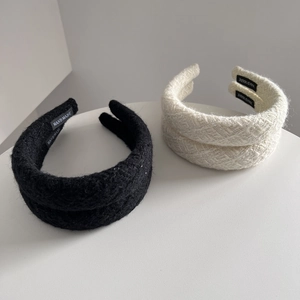 Detail of tweed headband texture showing premium weave and handmade interior label