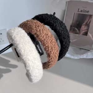 Detailed close-up of three wool sponge headbands in cream, coffee, and black tones
