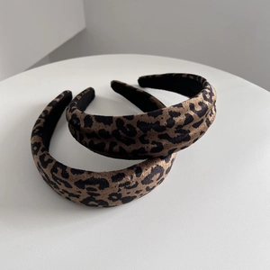 Detail view of leopard print faux suede headbands with high crown sponge padding