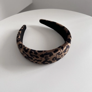 Detailed view of leopard print padded headband featuring premium faux suede texture