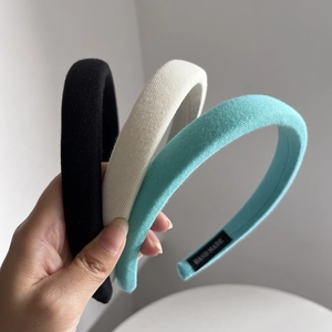 Three-pack padded cream sponge headbands in black, beige and blue knit fabric