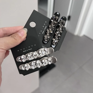 Sparkling crystal duckbill hair clips in black and silver set on a display card