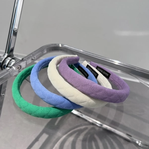 Detail of checkered padded headbands showing hand made label and assorted colors