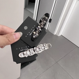 Elegant two-piece hair clip set with sparkling crystals in black and silver finishes