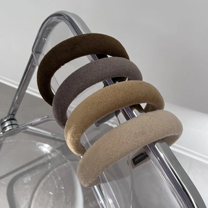 Set of four handmade plush wide headbands in neutral earth tones on transparent display