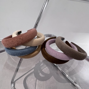 Detail of soft plush lamb wool headbands in multiple autumn colors on display