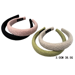 Set of four textured sponge headbands in black, pink, green, and beige colors