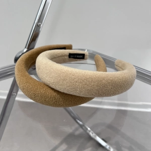 Detail of handmade padded headbands in velvet fabric with hand made label detail