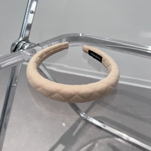 Detail showing the thick plaid fabric headband with a black Hand Made label on inner side