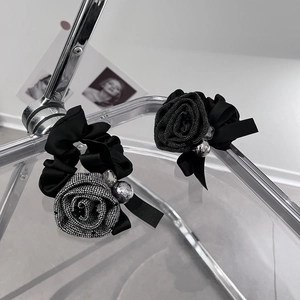 Elegant fabric rose hair scrunchies with checkered patterns and sparkling diamond accents