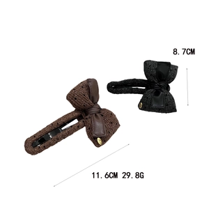 Elegant fabric bow hair clip with knit texture and golden Love tag in coffee and black