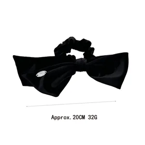Elegant black velvet bow hair scrunchie with silver metal charm and soft pleated texture