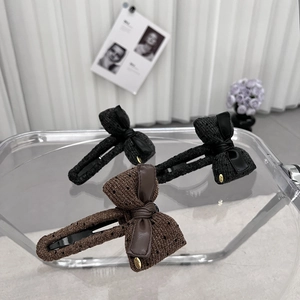 Elegant knit bow hair clips with gold LOVE charms and textured fabric in neutral colors