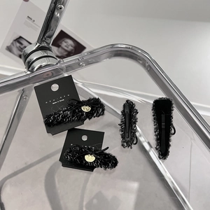 Elegant black and white tweed hair claw clips set with ribbon bows and heart charms