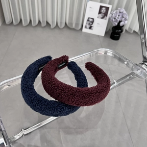 Thick faux shearling headbands in navy blue and burgundy with a handmade label