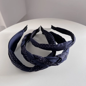 Three-piece navy blue polka dot headband set featuring braided, knotted, and wide fabric styles