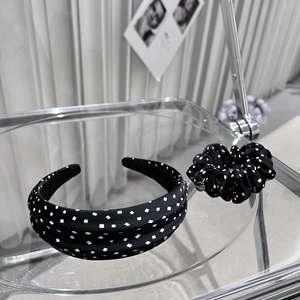 Polka dot headband and scrunchie set in black and white with a stylish satin finish