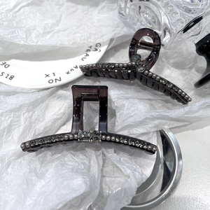 Detail of luxury hair claw clips with Czech crystals and pearls on brown resin finish