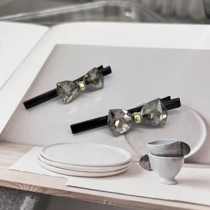 Elegant pair of sparkling bow hairpins with gray crystal on black alligator clips